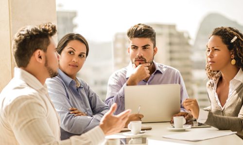 Group of business people sitting in the office on a business meeting and communicating.